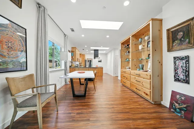 a kitchen with stainless steel appliances granite countertop a sink and wooden floor