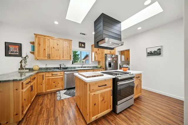 a kitchen with granite countertop a sink and a stove