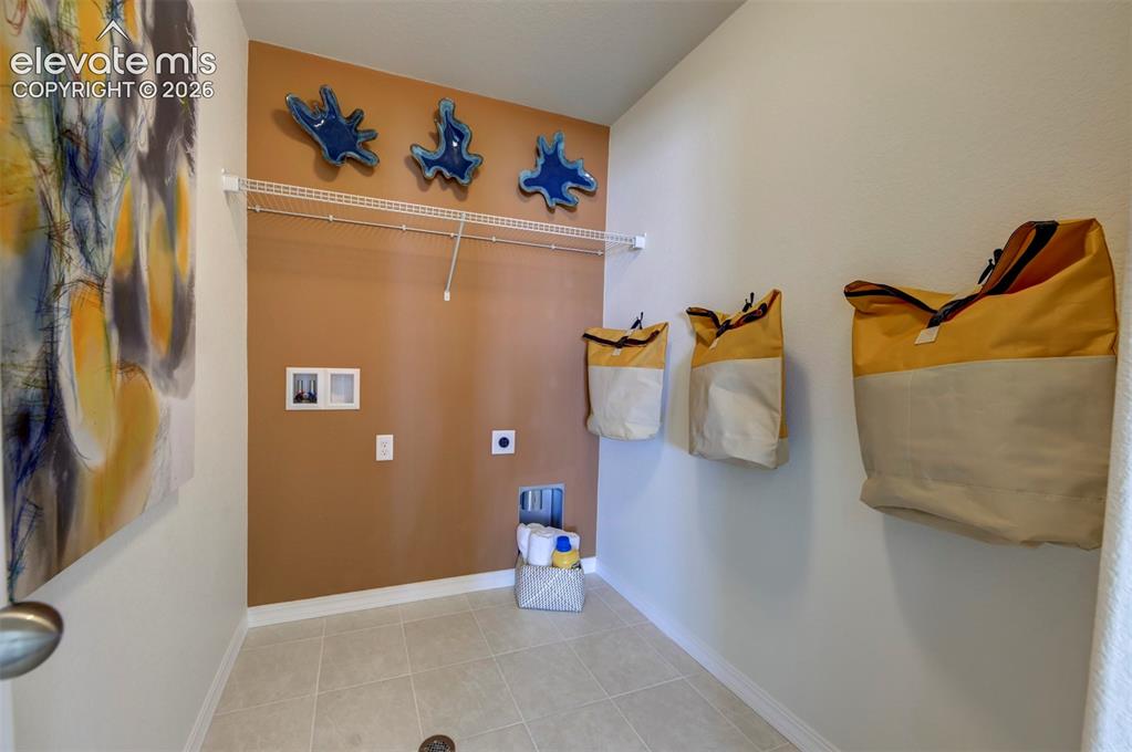 8230 Lemon Grass Road Falcon, CO 80831 - Photo 19 of 22 a view of walk in closet with clothes and shoes