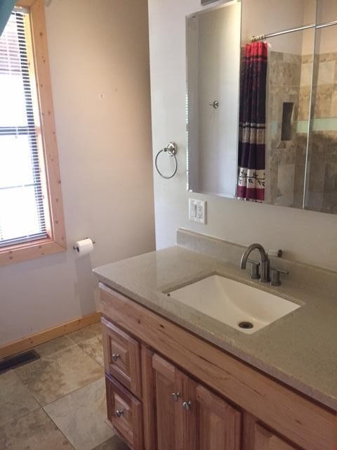 293 Harris Branch Road Madisonville, TN 37354 - Photo 14 of 31 a bathroom with a granite countertop sink and a mirror