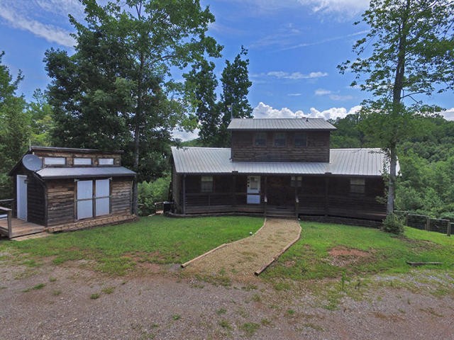 293 Harris Branch Road Madisonville, TN 37354 - Photo 2 of 31 a view of a house with a yard and a large tree