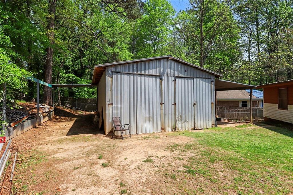 7019 Lake View Lane Doraville, GA 30360 - Photo 29 of 32 a backyard of a house with barbeque oven and wooden fence