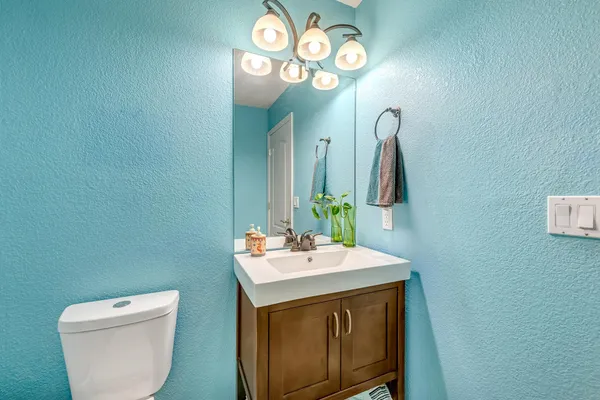 a bathroom with a toilet sink and mirror