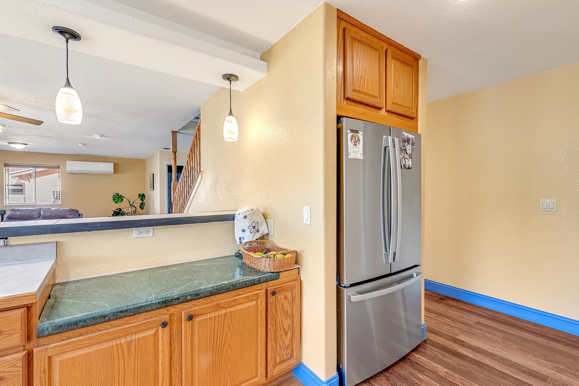 927 Crown Court Fruita, CO 81521 - Photo 15 of 42 a kitchen with stainless steel appliances granite countertop a refrigerator a oven and white cabinets with wooden floors