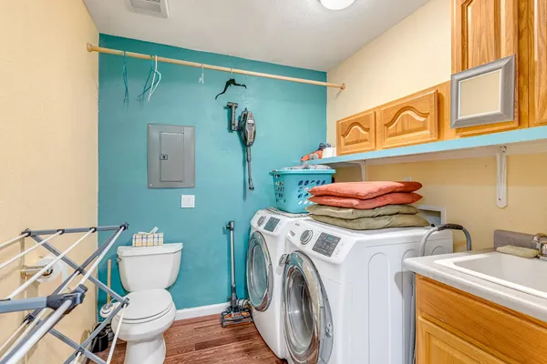 a bathroom with a sink and a washer dryer
