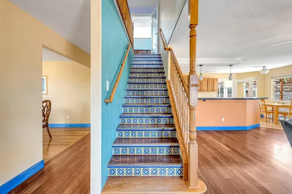 a view of entryway and hall with wooden floor