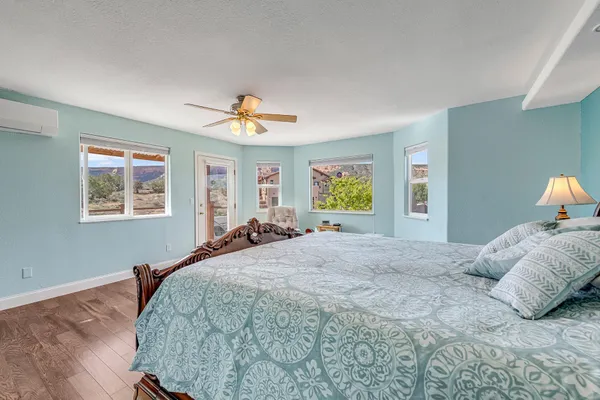 a bedroom with a bed and wooden floor