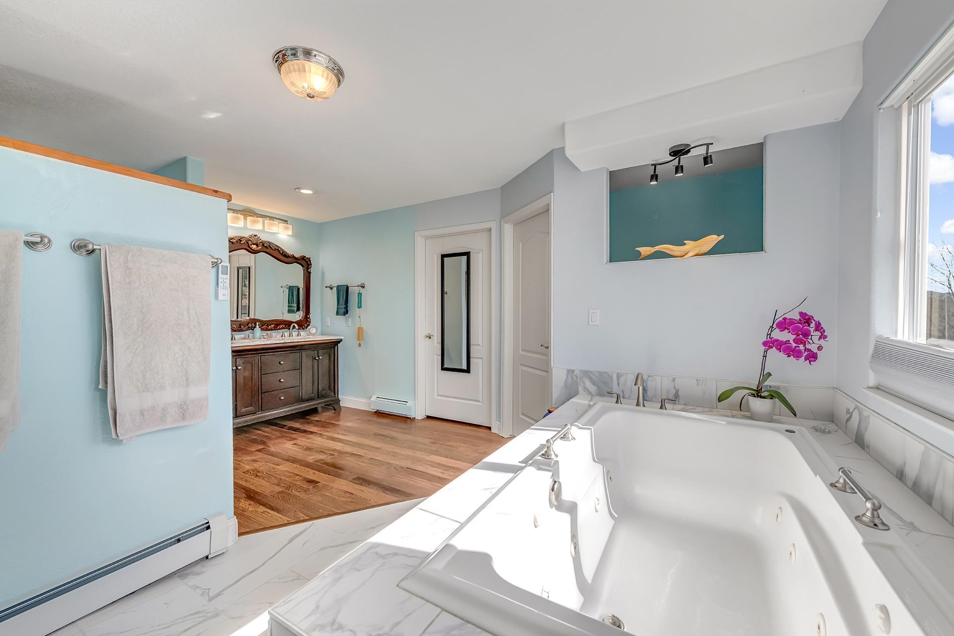 927 Crown Court Fruita, CO 81521 - Photo 27 of 42 a bedroom with a bed and a chandelier