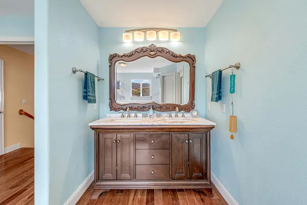 a view of bathroom with a sink and mirror