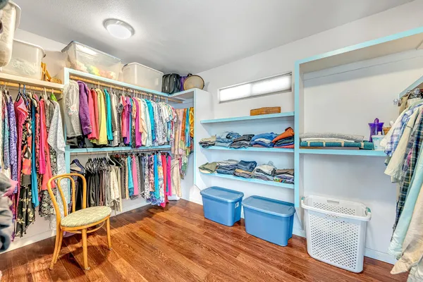 a view of a kitchen with fridge and wooden floor