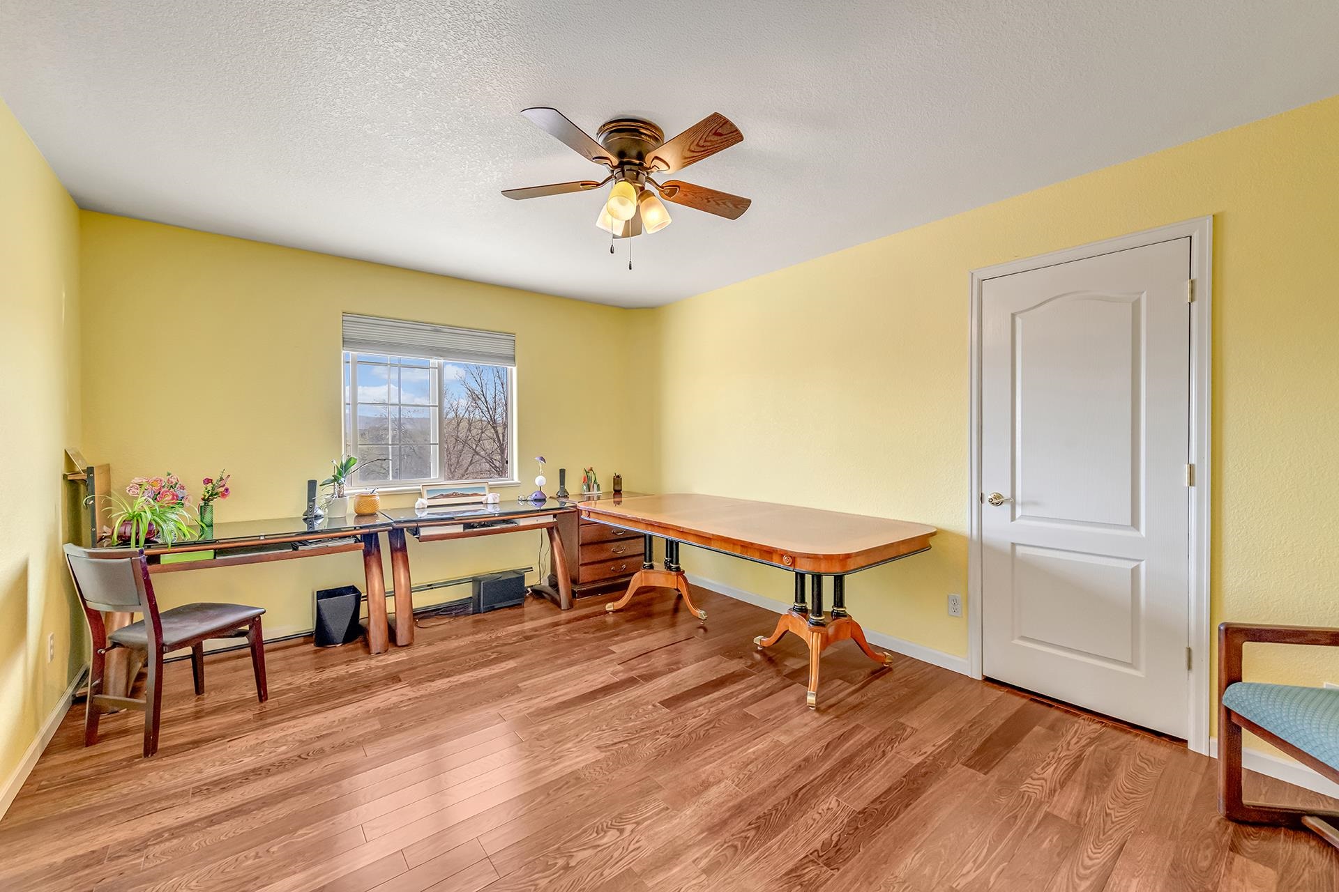 927 Crown Court Fruita, CO 81521 - Photo 32 of 42 a view of a room with furniture and wooden floor