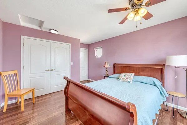 a bedroom with a bed and a chandelier