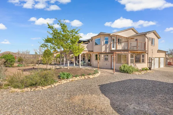 a front view of a house with a yard and lake view
