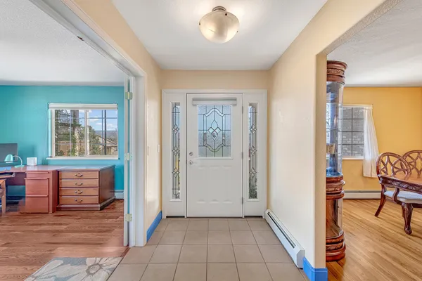 a view of a livingroom with workspace and a window