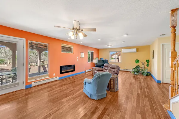 a living room with furniture a fireplace and a flat screen tv