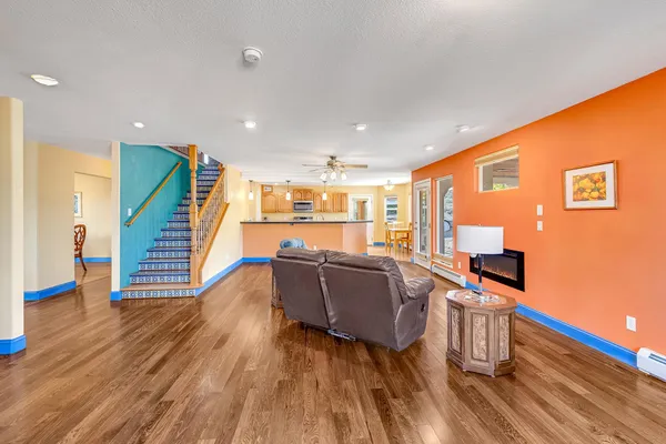 a living room with furniture and a wooden floor