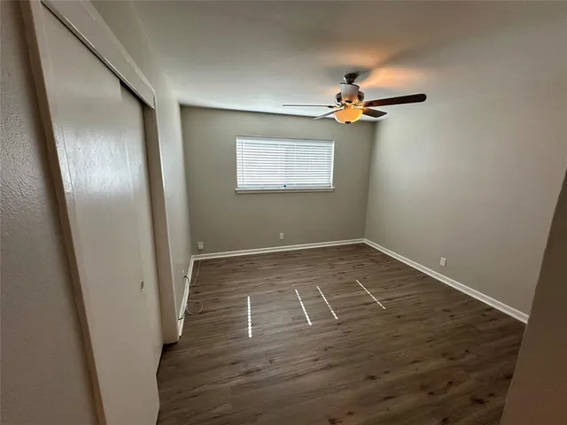 wooden floor in an empty room with a mirror