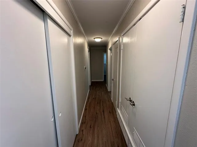 a view of hallway with wooden floor