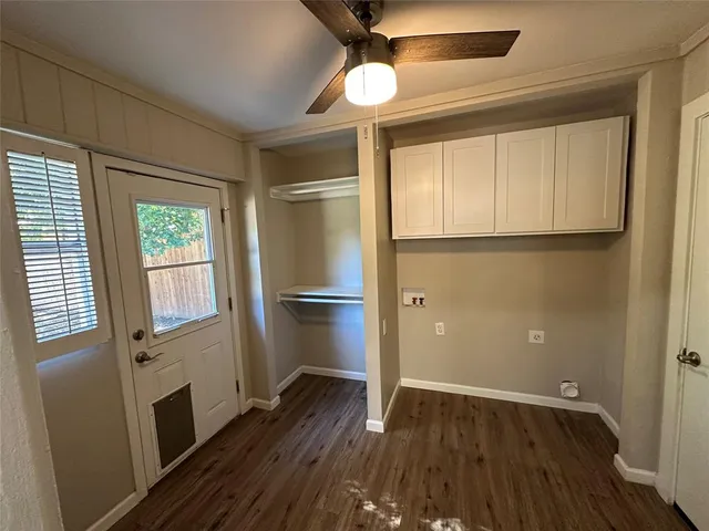 a view of empty room with wooden floor and window