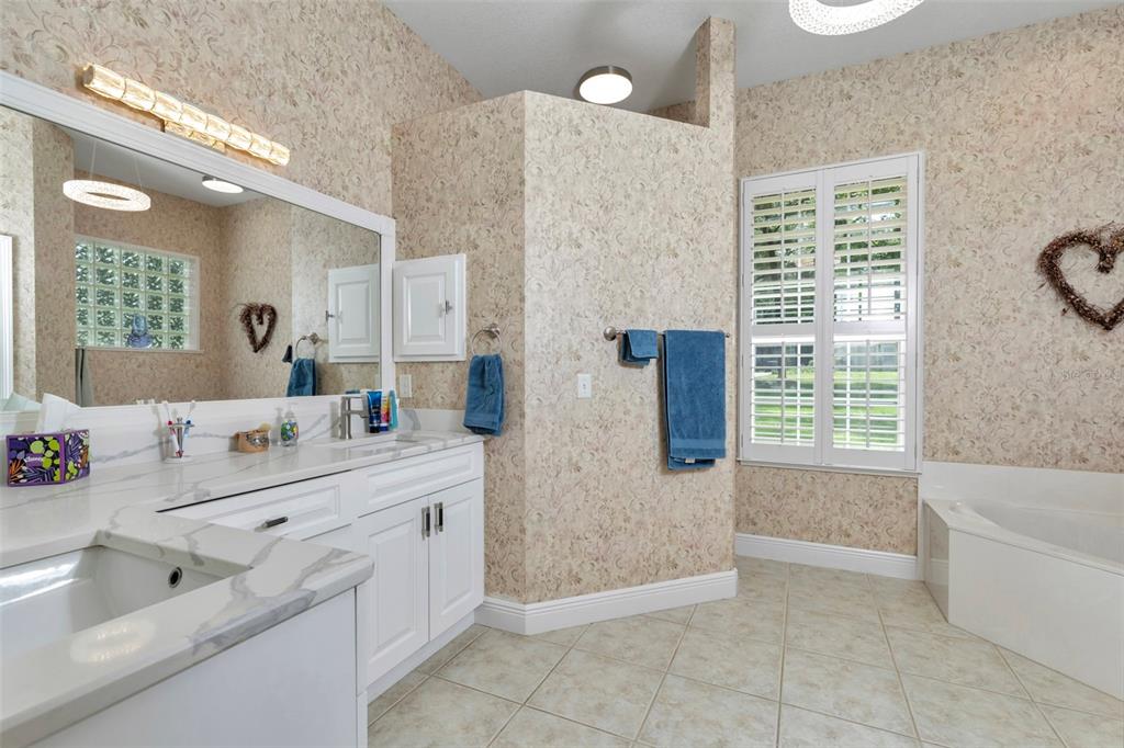 1989 Northwest 111th Loop Ocala, FL 34475 - Photo 28 of 55 a bathroom with a tub sink and mirror