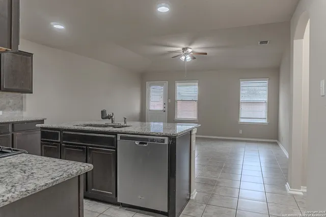 a kitchen that has a sink and a stove in it
