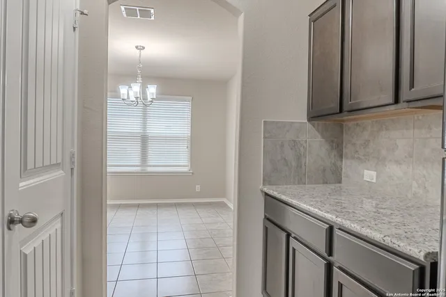 a view of a kitchen cabinets and chandelier