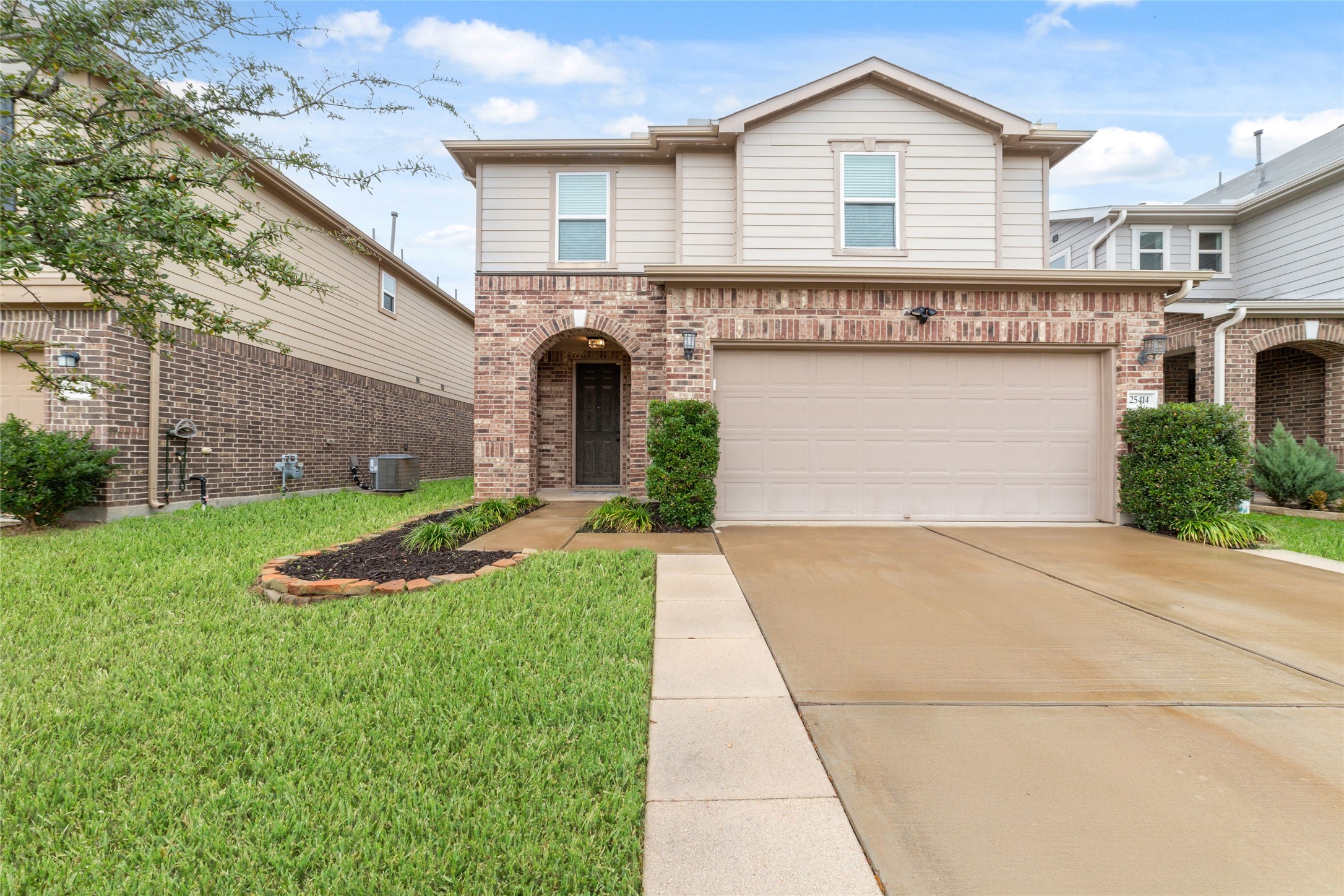 a front view of a house with a yard and garage