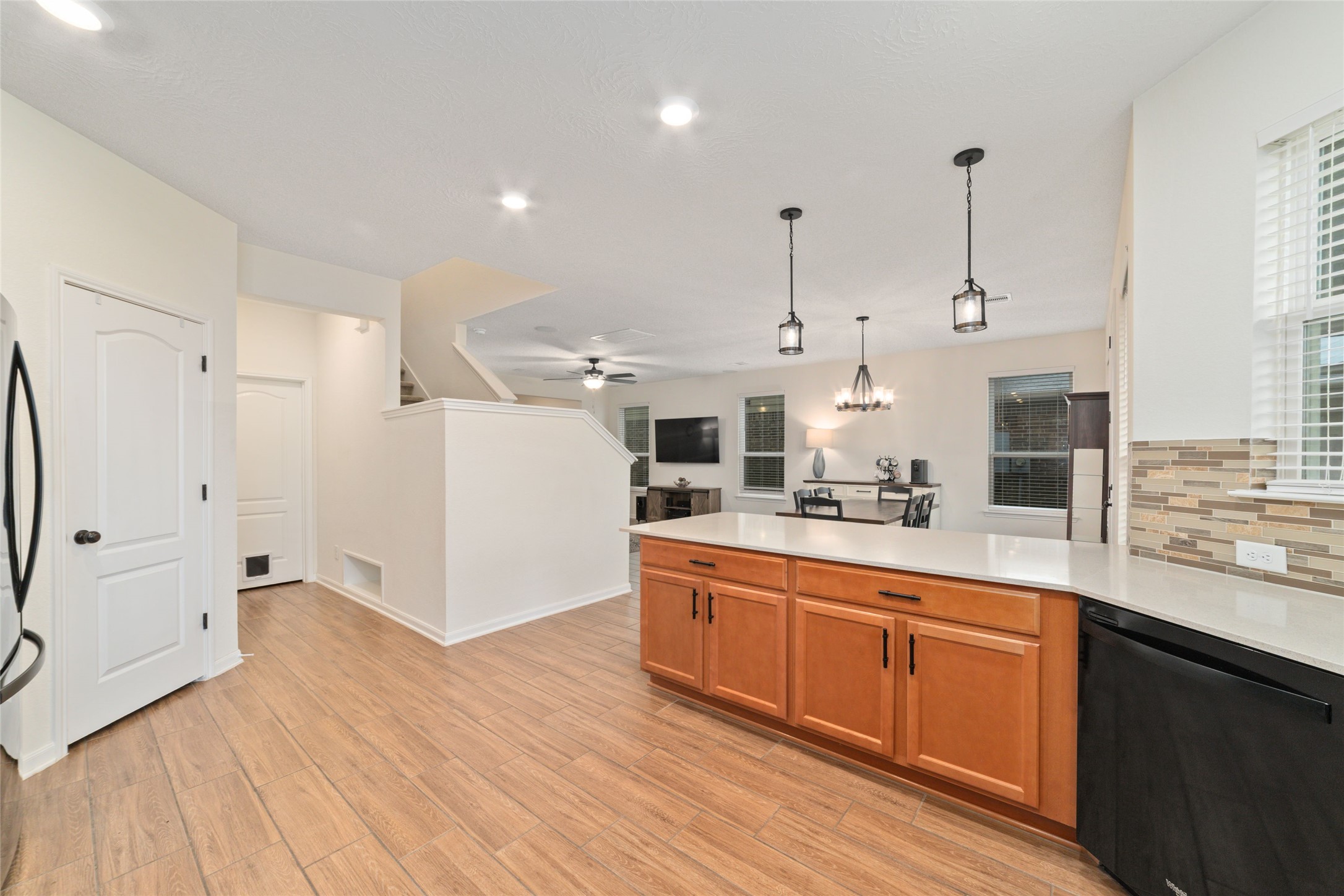 25414 Whitehaven Gate Street Katy, TX 77493 - Photo 15 of 32 a large white kitchen with a stove a sink dishwasher and a refrigerator with wooden floor