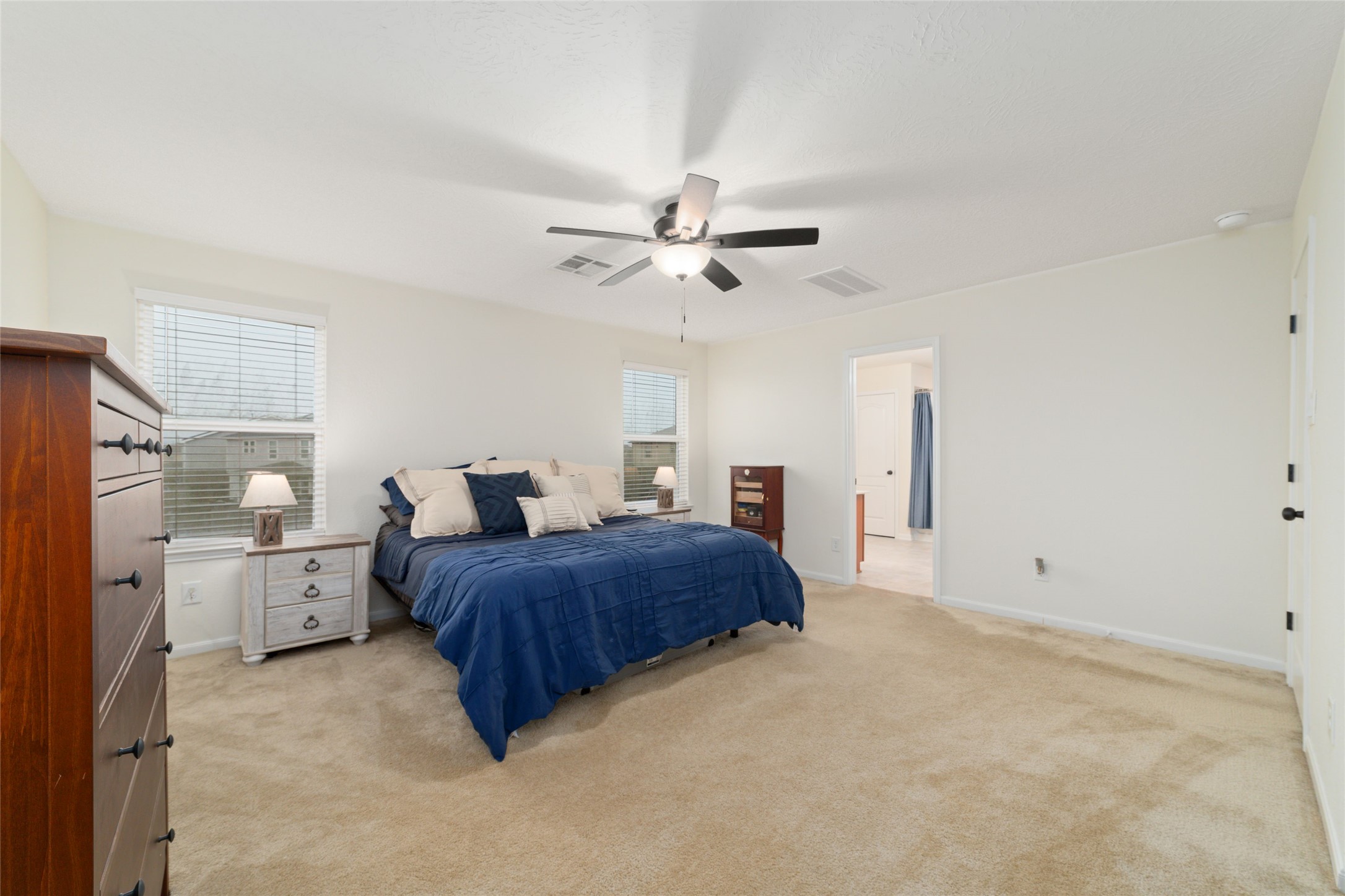 25414 Whitehaven Gate Street Katy, TX 77493 - Photo 20 of 32 a spacious bedroom with a bed and window