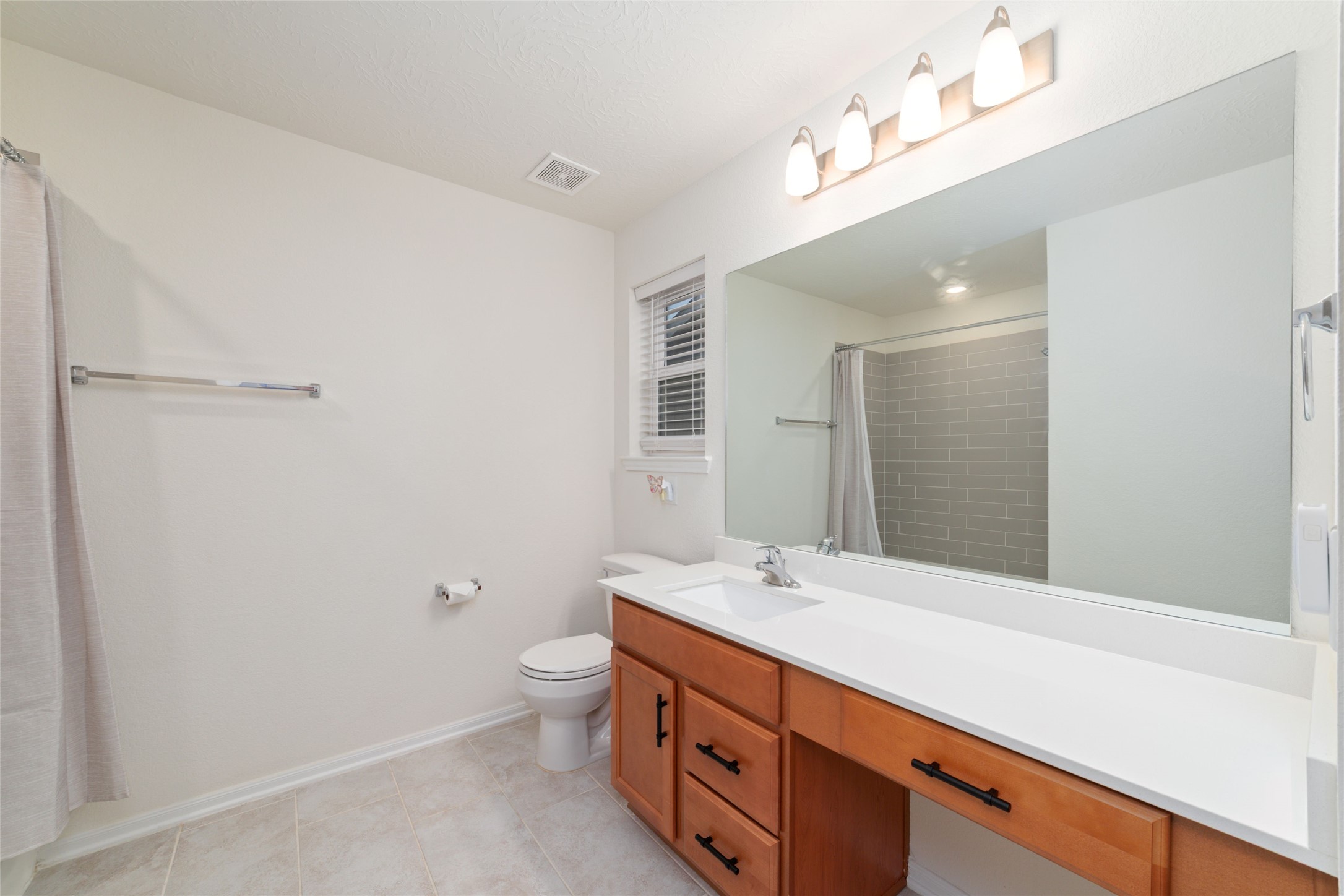 25414 Whitehaven Gate Street Katy, TX 77493 - Photo 28 of 32 a bathroom with a double vanity sink toilet and a mirror