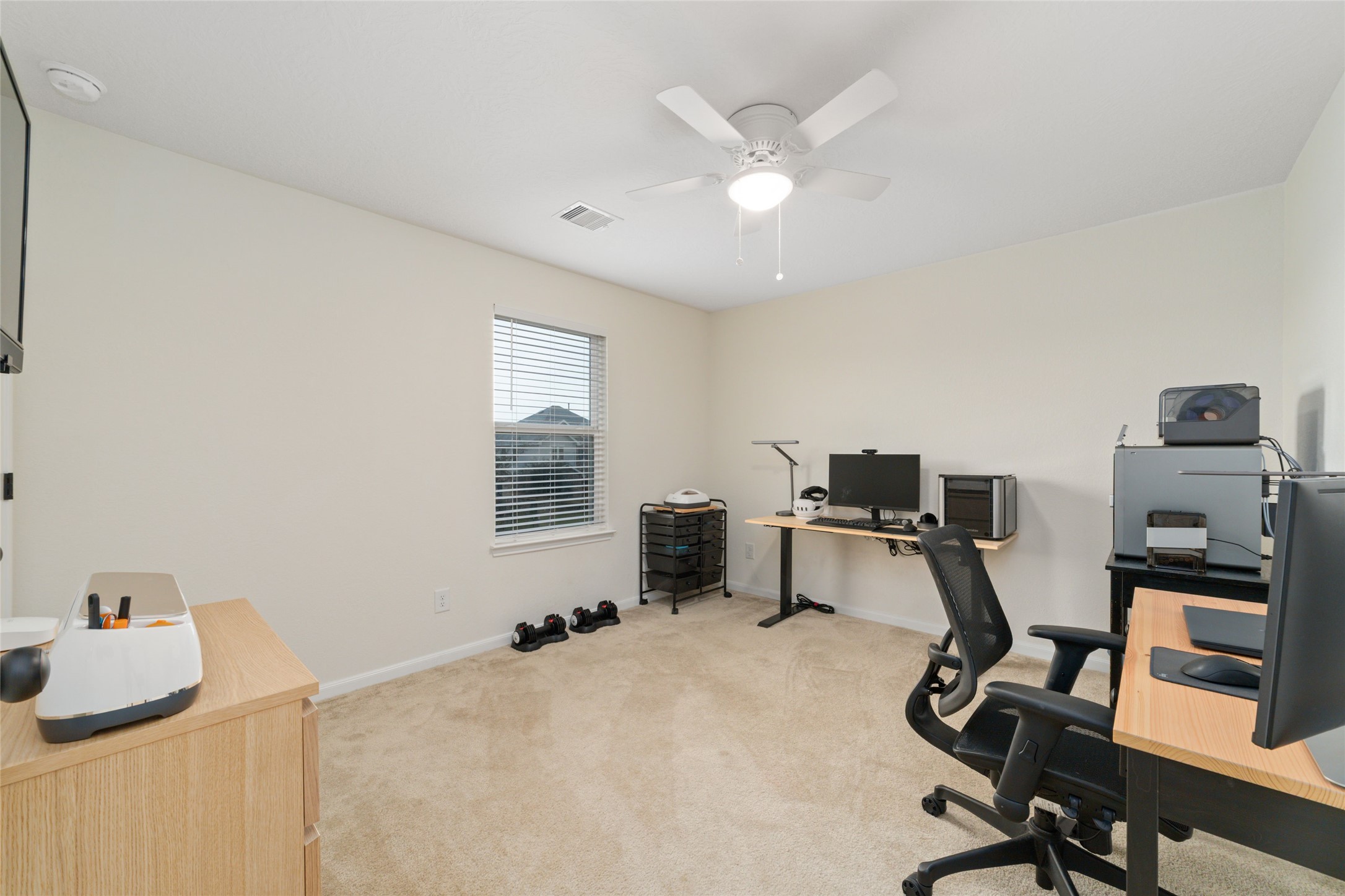 25414 Whitehaven Gate Street Katy, TX 77493 - Photo 30 of 32 a view of a workspace with furniture and a window