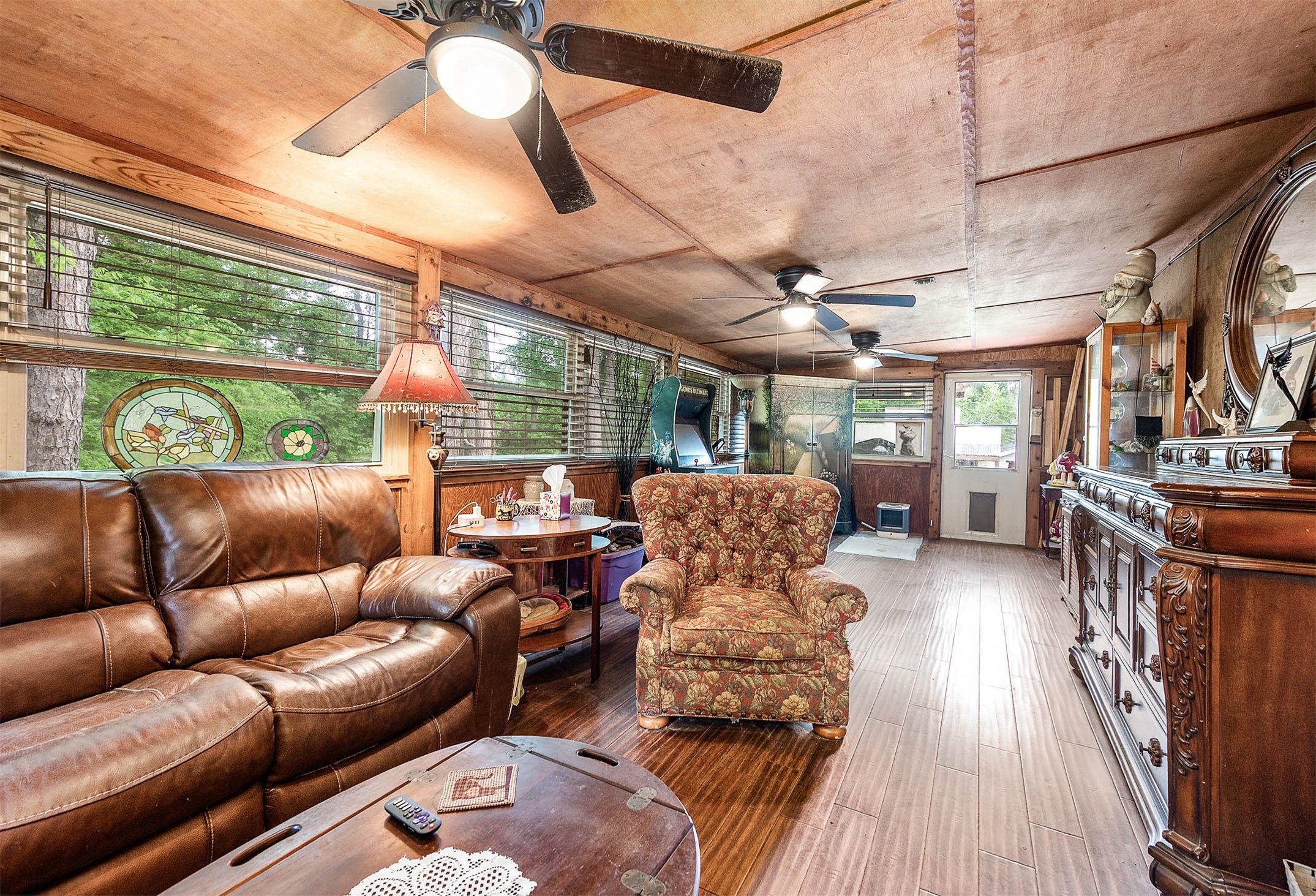 100 Magnolia Place Coldspring, TX 77331 - Photo 15 of 50 a living room with furniture a fireplace and a chandelier