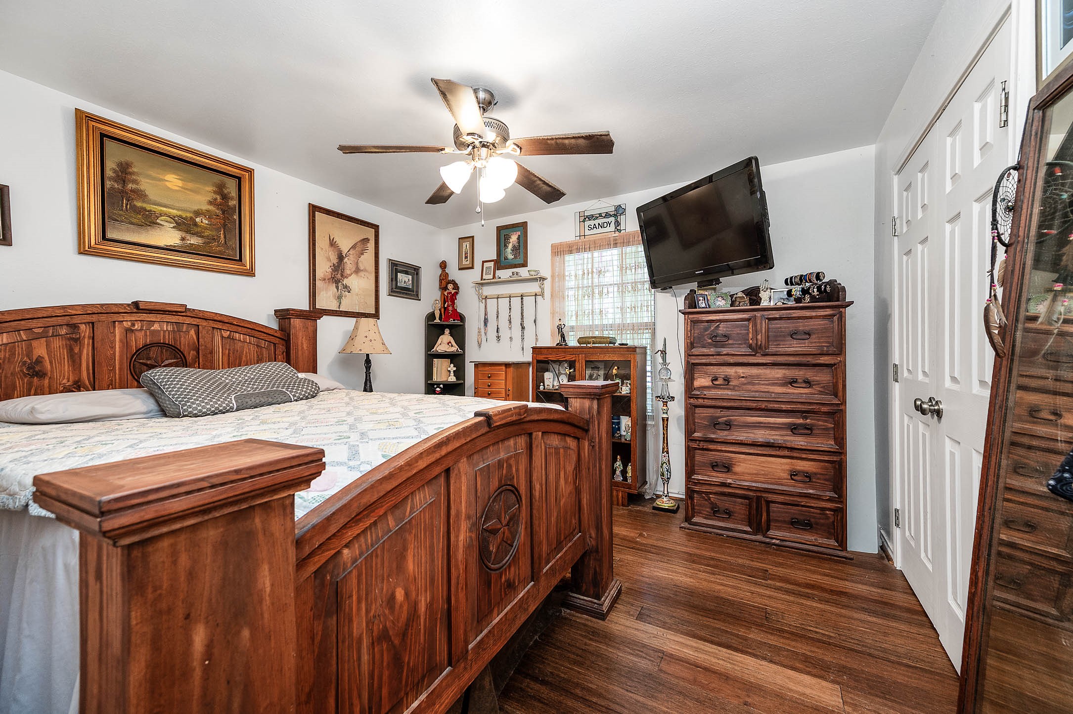 100 Magnolia Place Coldspring, TX 77331 - Photo 19 of 50 a bedroom with furniture and a flat screen tv