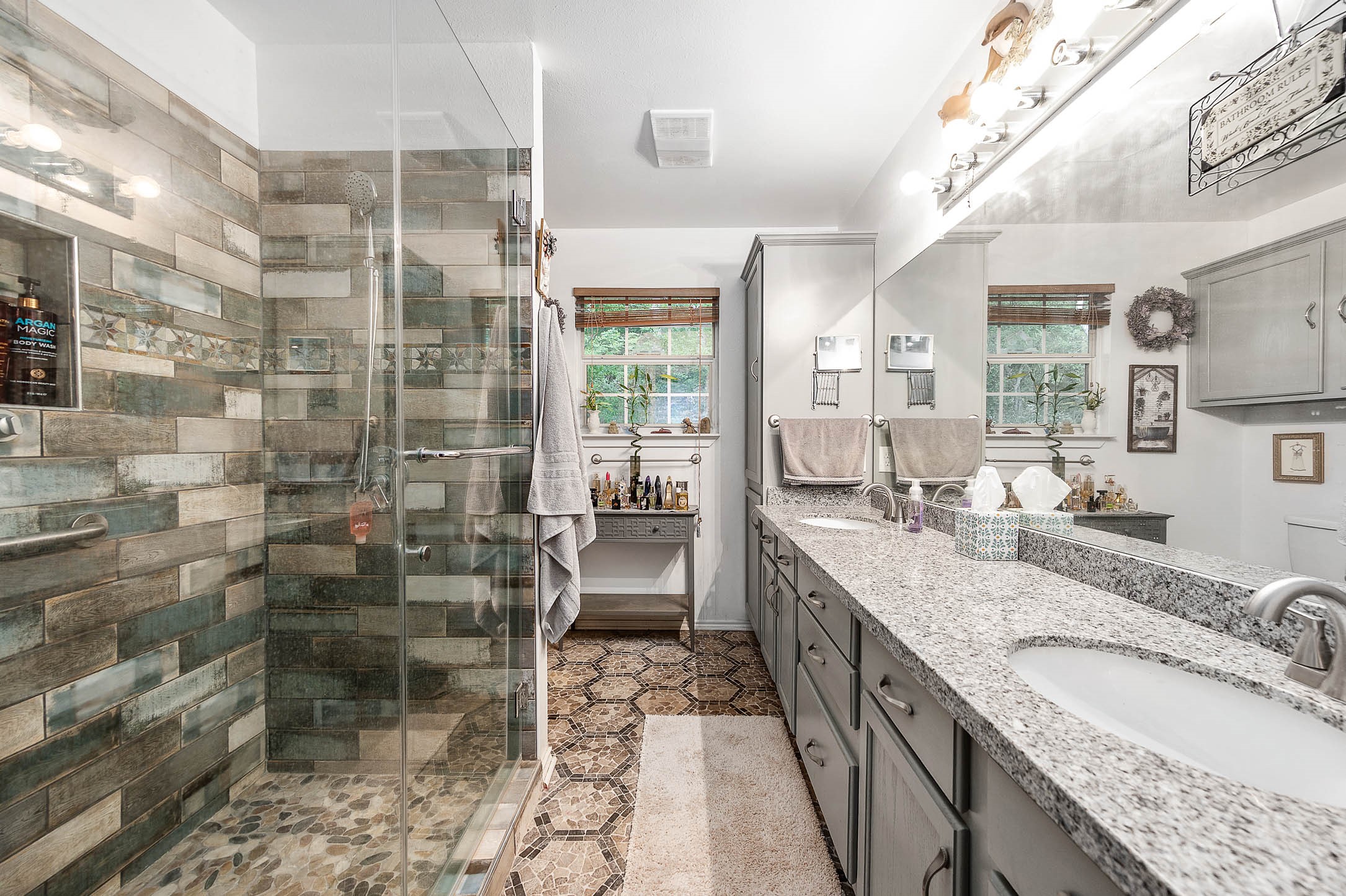 100 Magnolia Place Coldspring, TX 77331 - Photo 25 of 50 a large bathroom with a granite countertop double vanity and a mirror