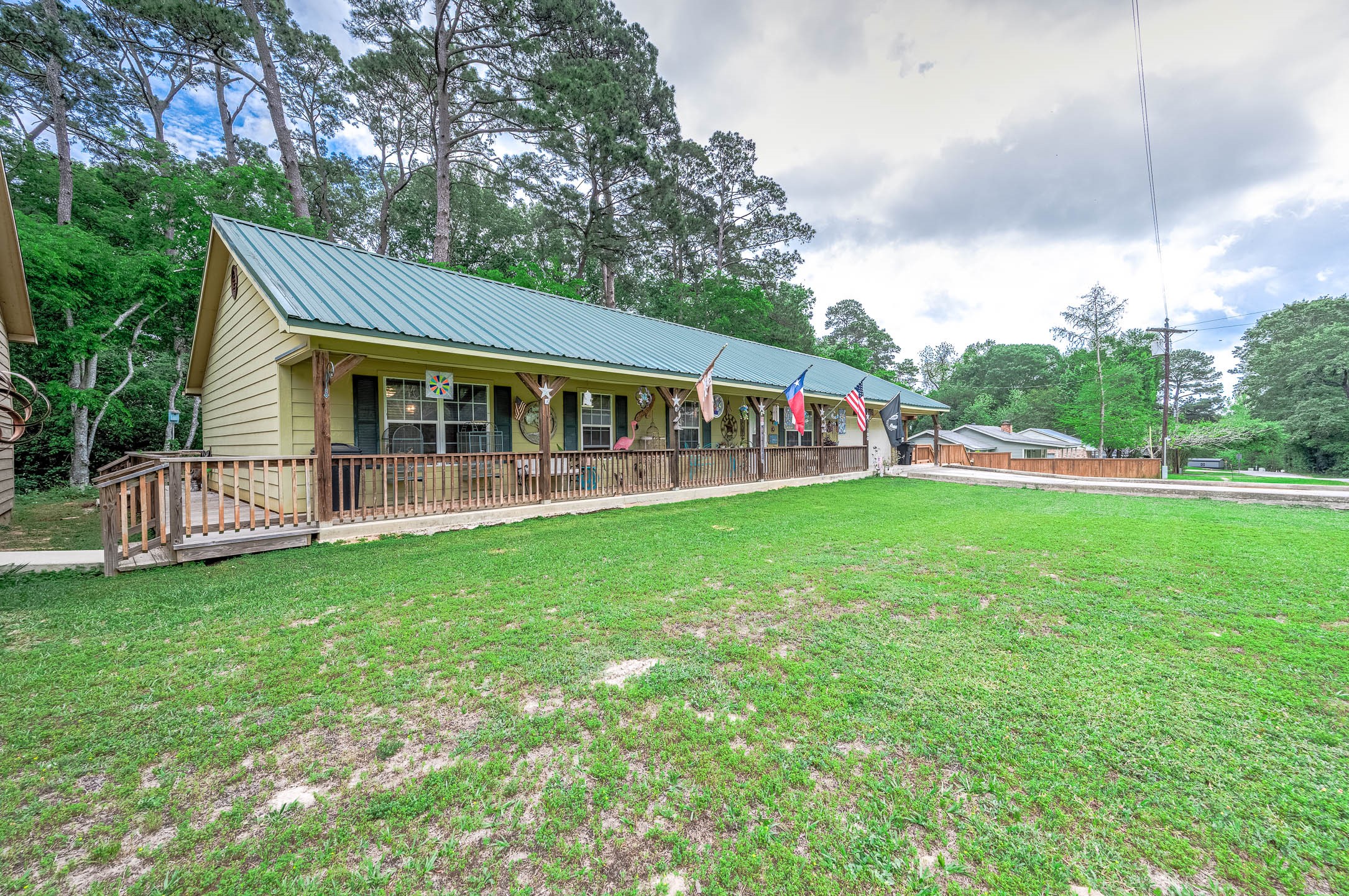 100 Magnolia Place Coldspring, TX 77331 - Photo 3 of 50 a view of a house with a big yard and large trees
