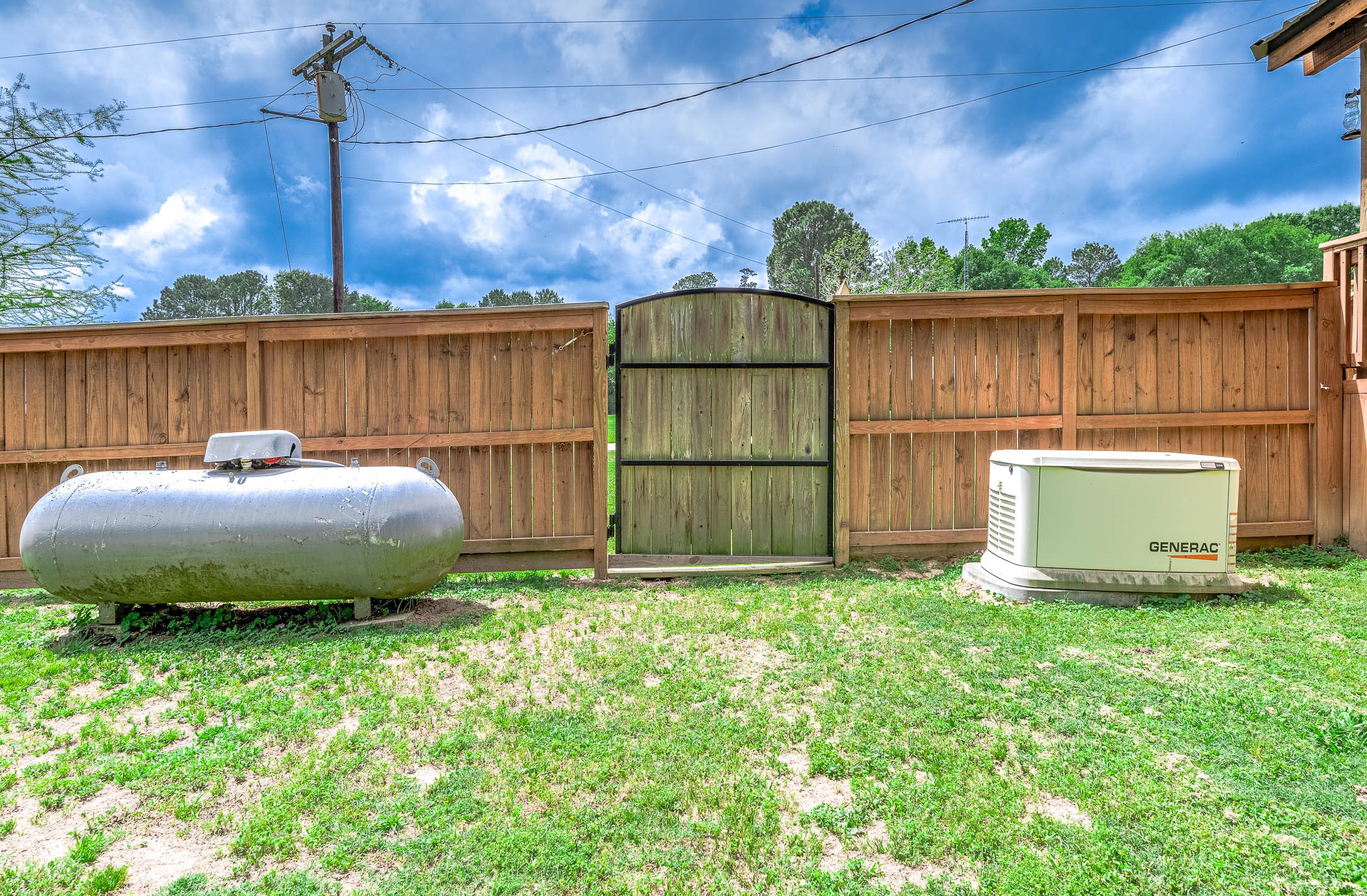 100 Magnolia Place Coldspring, TX 77331 - Photo 35 of 50 a view of a backyard with table and chairs a fire pit