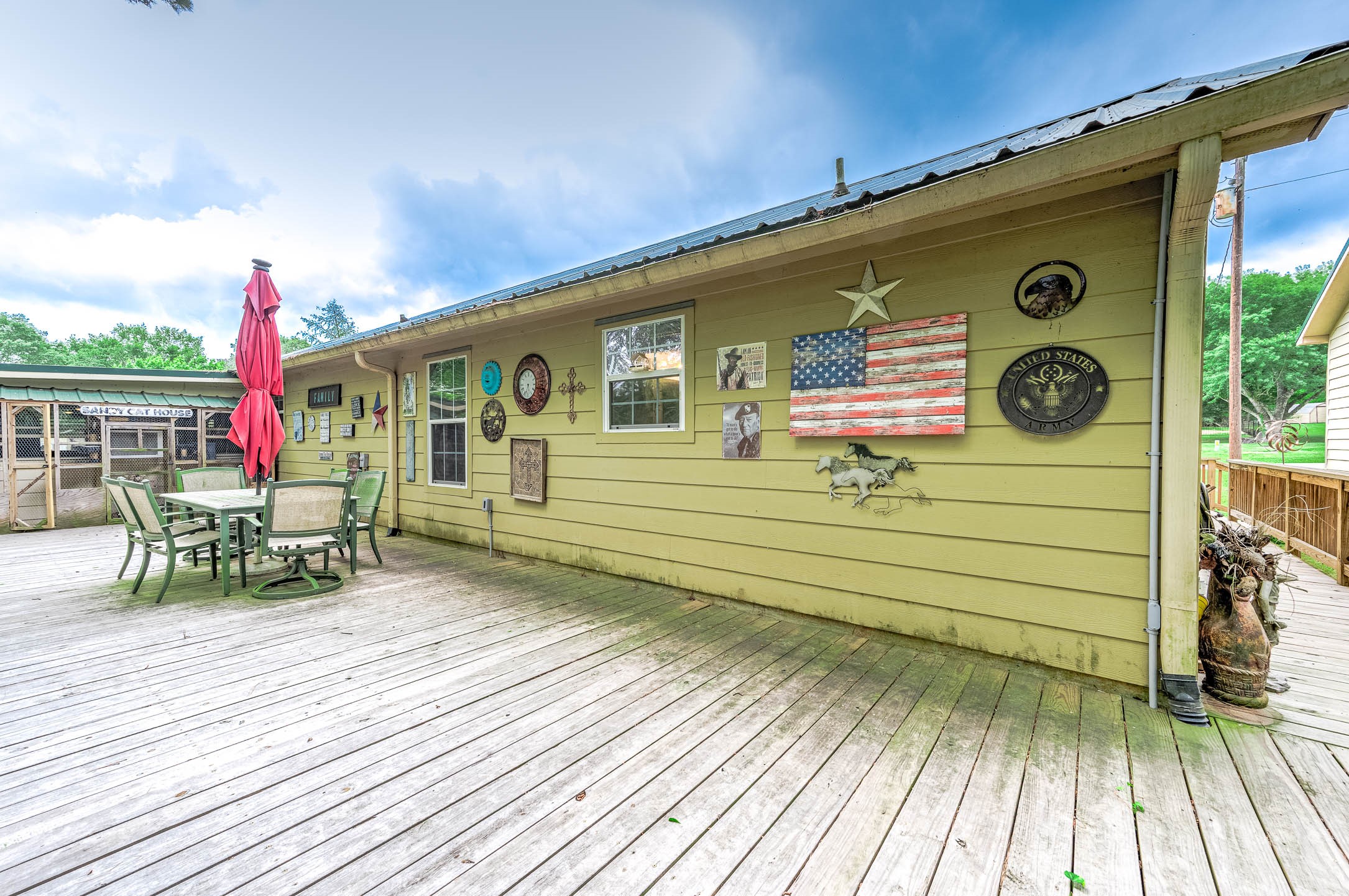 100 Magnolia Place Coldspring, TX 77331 - Photo 42 of 50 a front view of a house with outdoor seating and wooden floor