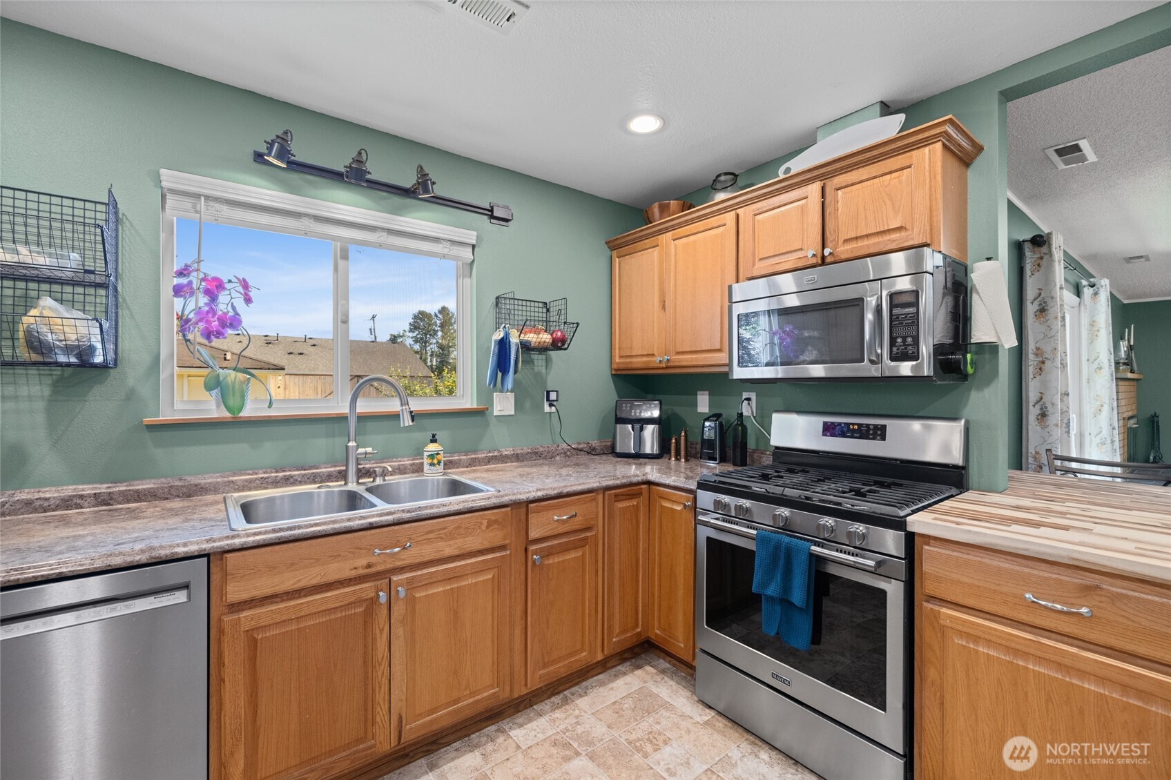 415 Sterling Street Sedro-Woolley, WA 98284 - Photo 19 of 38 a kitchen with stainless steel appliances granite countertop a stove sink and cabinets