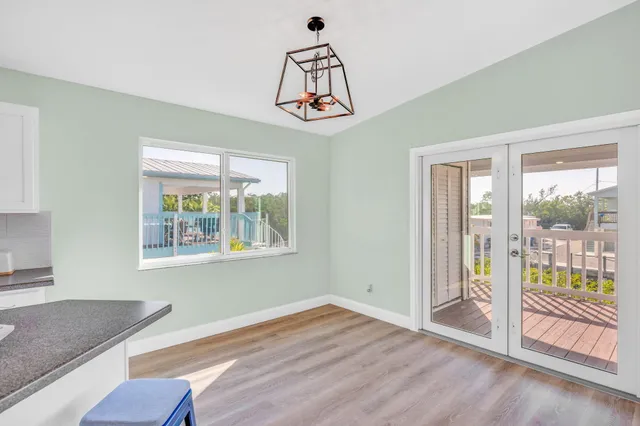 a bathroom with a granite countertop sink a mirror and a toilet