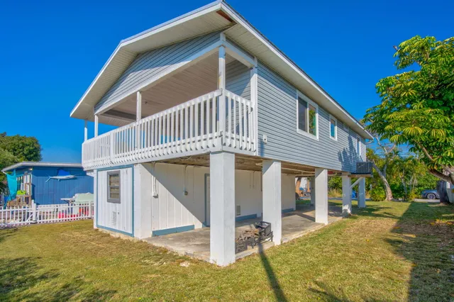 a view of a house with backyard and stairs
