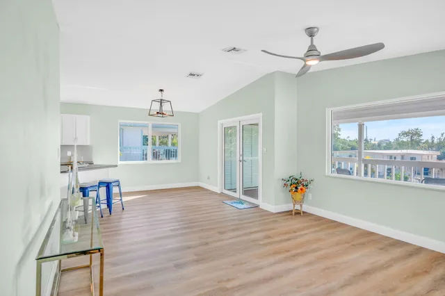 a view of a kitchen with furniture and wooden floor