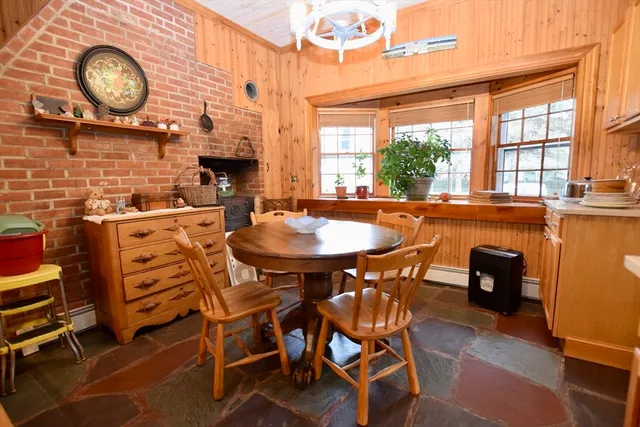 a dining room with furniture and a large window