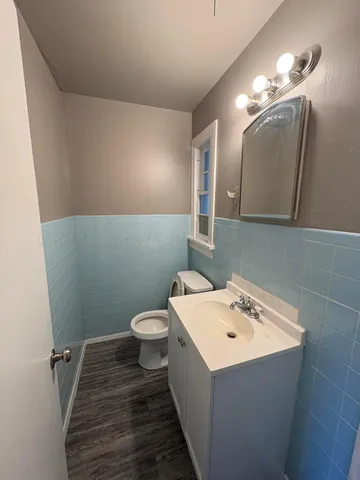 a bathroom with a sink a toilet and mirror