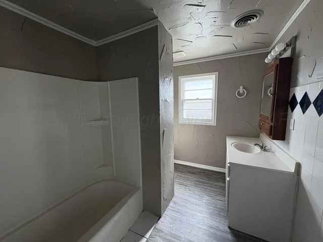 a bathroom with a sink a shower and a mirror