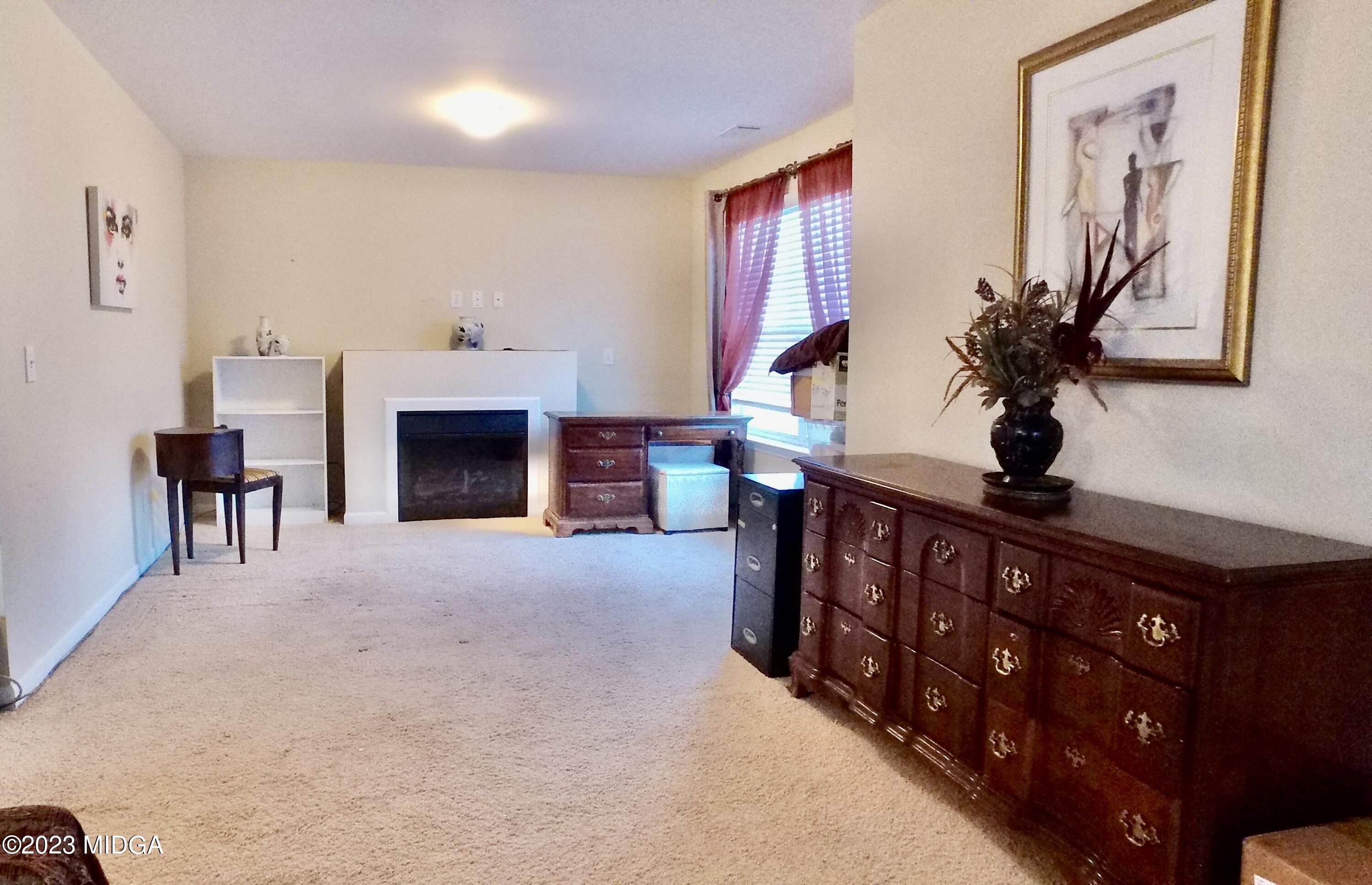 901 Broderick Circle Warner Robins, GA 31088 - Photo 13 of 19 a living room with furniture a fireplace and a potted plant