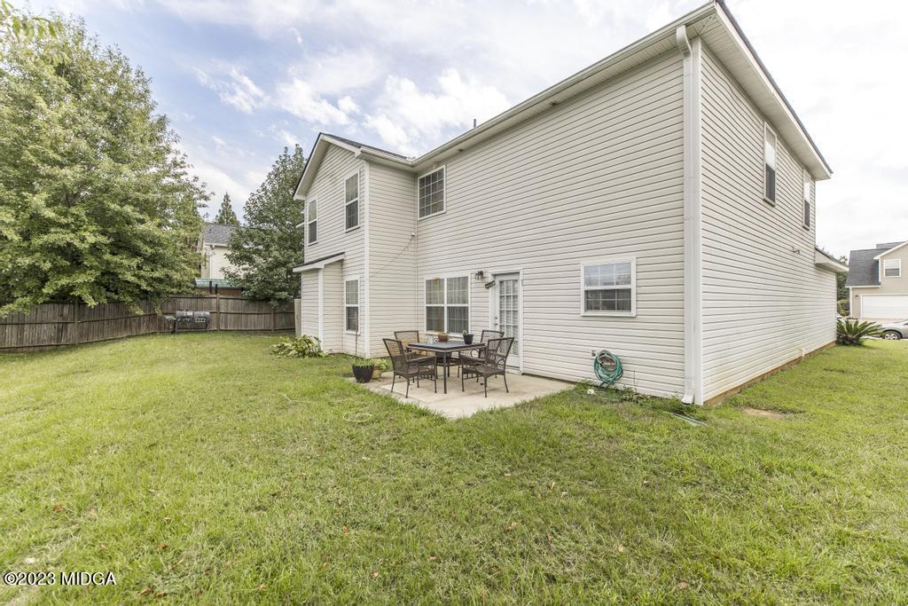 901 Broderick Circle Warner Robins, GA 31088 - Photo 18 of 19 a view of backyard of house with wooden deck and seating space