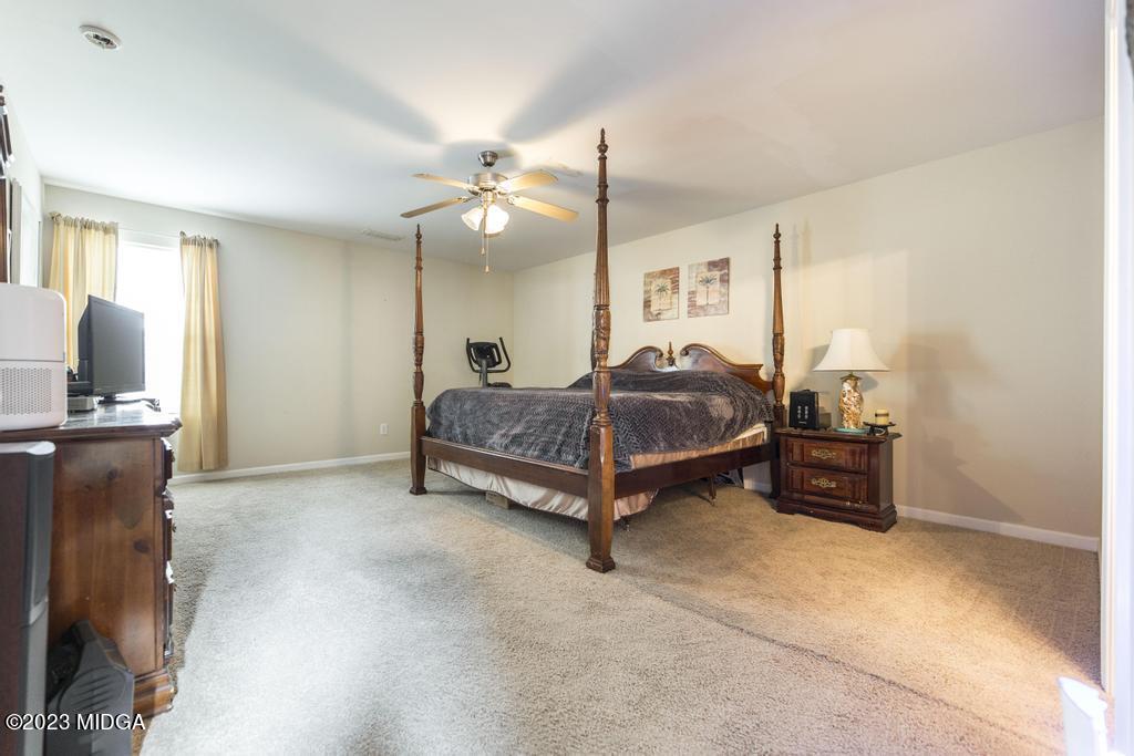 901 Broderick Circle Warner Robins, GA 31088 - Photo 8 of 19 a spacious bedroom with a bed and wooden floor