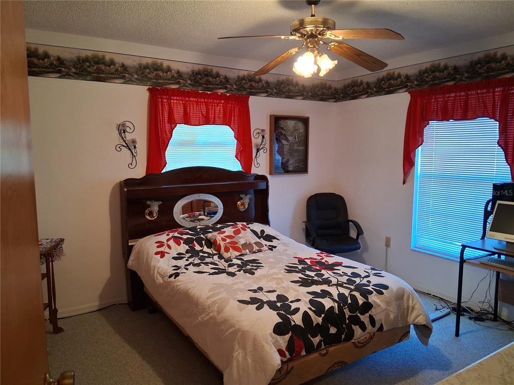 515 Boitnott Lane Bushnell, FL 33513 - Photo 13 of 13 a bedroom with a bed and a fireplace