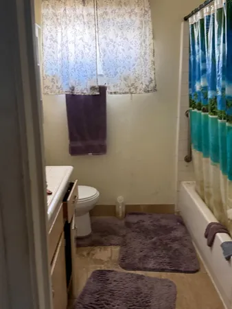 a bathroom with a toilet a sink and bathtub