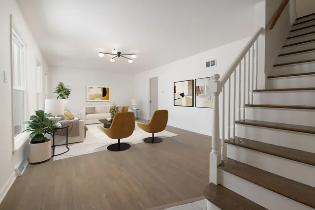 a living room with furniture potted plant and a chandelier